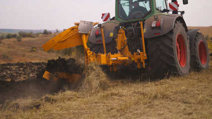 Tractor working in the field. Autumn tillage. Deep ripping with powerful tractor