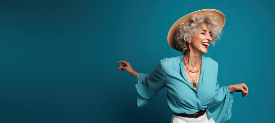 Older Fashionable Lady Dancing Against a Blue Background with Space for Copy (Generative AI) - obrazy, fototapety, plakaty