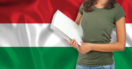 Half-length portrait of a female student with a folder. Foreign language teaching concept.