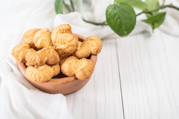 biscuits with orange and vanilla flavors in a plate on white wooden background
