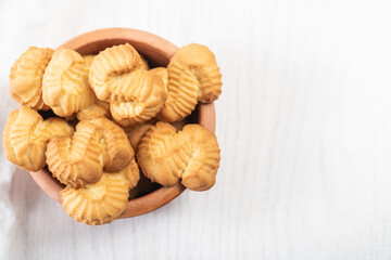 biscuits with orange and vanilla flavors in a plate on white wooden background
