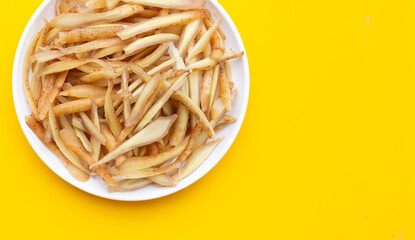 Sliced finger root on yellow background.