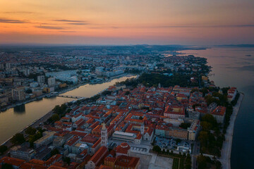 Fototapeta premium Scenic aerial view of Zadar old city, beautiful cityscape in dusk before sunrise, Dalmatia, Croatia. Famous tourist resort on Adriatic sea coast, outdoor travel background