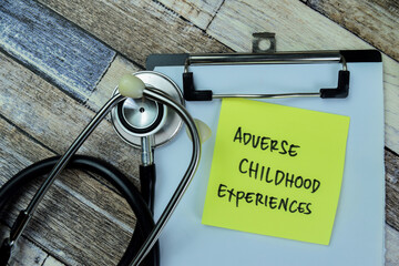 Concept of Adverse Childhood Experiences write on sticky notes isolated on Wooden Table.