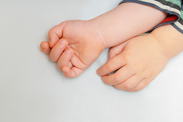 Cute little newborn infant baby child hands in bed, sleeping lying. happy family day, daycare nursery