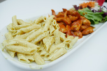pasta, chicken and fresh salad on a plate 