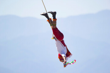 Volador is flying on the rope in ancient ritual dance in Mexico.