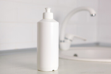 Dishwashing detergent on the background of the kitchen