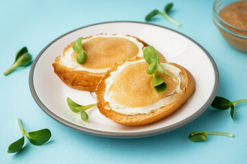 Delicious canape with caviar of capelin and microgreen on blue background