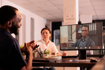 Remote coworkers talking on corporate videocall using webcam software on computer, employees discussing business plan on online meeting. Businessman listening to colleague on videoconference
