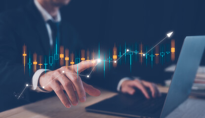 investment financial and saving concept, businessman working on table with computer laptop and  virtual trading graph, business growth and investment strategy. stock market trading, economy exchange