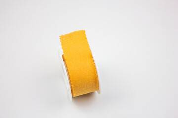 Plaster medical for wounds.Reel with a plaster on a white background. Yellow medical patch.