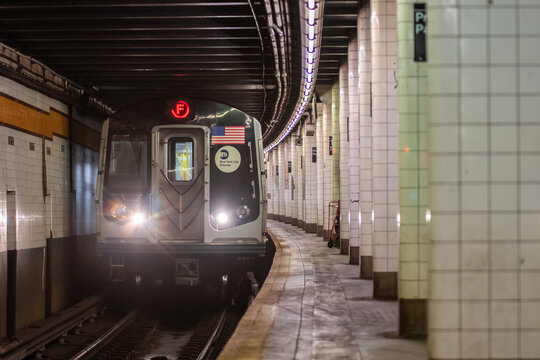 New York, The USA, October: NYC Subway train was stoped on platform. NYC train going to platform in subway.