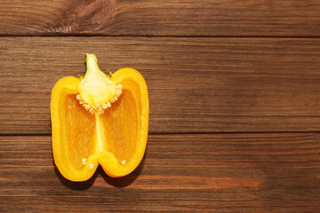 yellow sweet pepper on a wooden background, space for text.