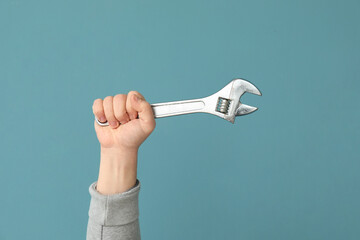 Worker with wrench on blue background