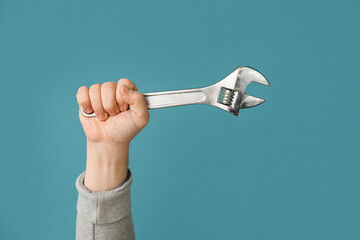 Worker with wrench on blue background