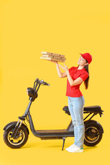 Fototapeta na wymiar Female courier with scooter and tasty pizza on yellow background