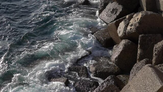 Stormy beautiful waves are crushing on huge rocks on the sea coast in Cadiz.