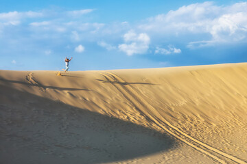 Happy family - kids running and jumping high in the air from sea beach sand dune. Active people, outdoor activity on tropical summer vacations with children.