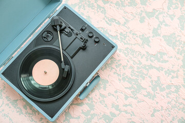Record player with vinyl disk on grunge background