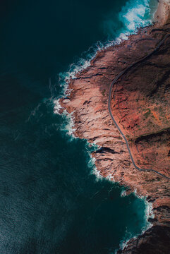 Aerial photo of ocean waves crashing on rock