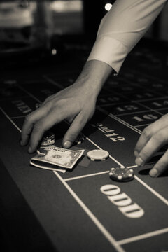 Grayscale photo of person playing poker in close-up