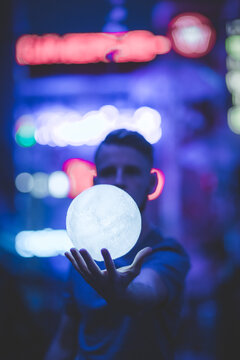 Man holding floating lit ball