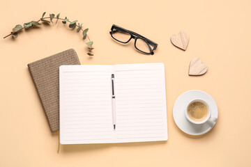 Composition with blank notebook, coffee cup and glasses on beige background