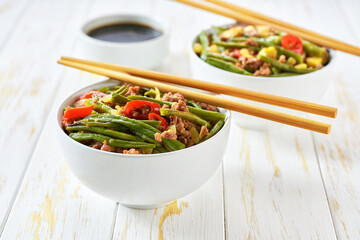pork dish with bean sprouts red pepper, garlic,ginger and soy sauce on white table. Chinese cuisine.