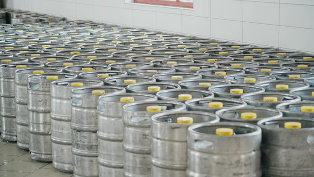 Stainless steel beer keg barrels where the finished beer is stored for sale at the brewery.