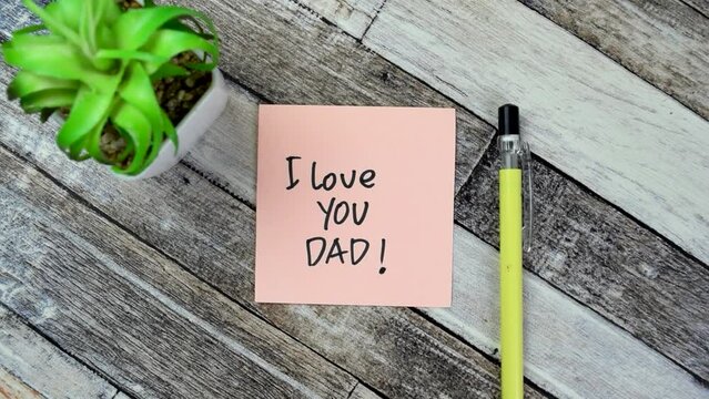 Concept of I Love You Dad! write on sticky notes isolated on Wooden Table.