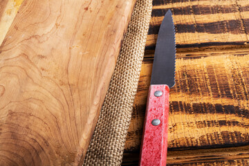 knife and cutting board on burlap, close-up. Space for text.