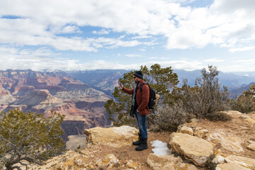 Hiker taking pictures of the Grand Canyon National Park, Arizona, USA