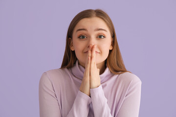 Happy young woman in sweater on lilac background, closeup