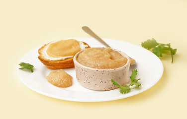 Bowl with caviar of capelin and canape on beige background