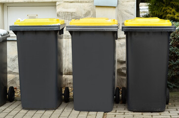 View of garbage containers in city on winter day