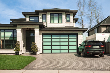 Real Estate Exterior Front House on a sunny day. Big custom made luxury house with nicely landscaped front yard