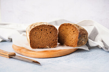 Board with sliced rye bread on grey table
