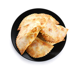 Plate of baked meat empanadas on white background