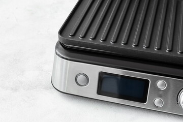 Fototapeta premium Control panel of modern electric grill on white table, closeup