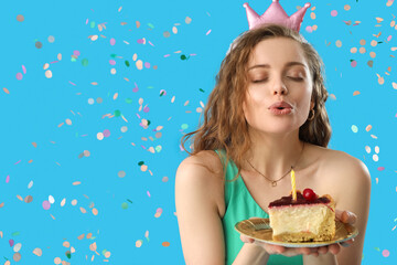 Young woman with piece of Birthday cake making wish on blue background