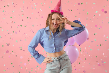 Obraz na płótnie Canvas Happy young woman celebrating Birthday on pink background