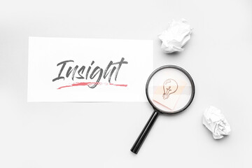 Word INSIGHT, crumpled paper, magnifier and drawn light bulb on light background