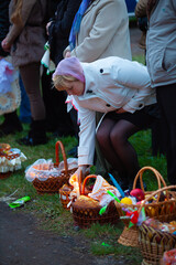 Woman lighting a candle in an Easter basket