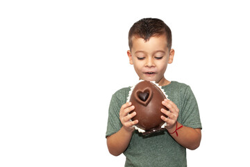 happy little boy with easter chocolate egg on light background