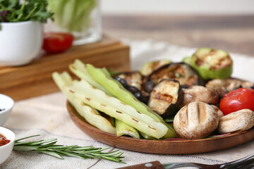 Plate with tasty grilled vegetables on table, closeup