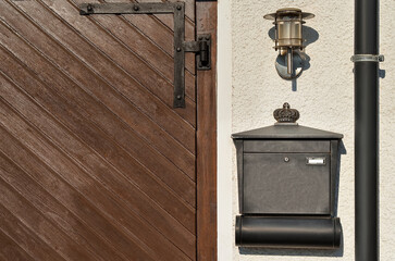 View of black mailbox and lamp on building wall