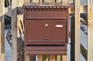 View of mailbox on wooden fence, closeup