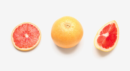Whole and cut grapefruits isolated on white background