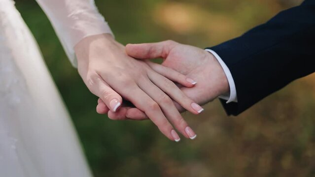 The girl gently touches her man's hand with her hand. Close-up shooting